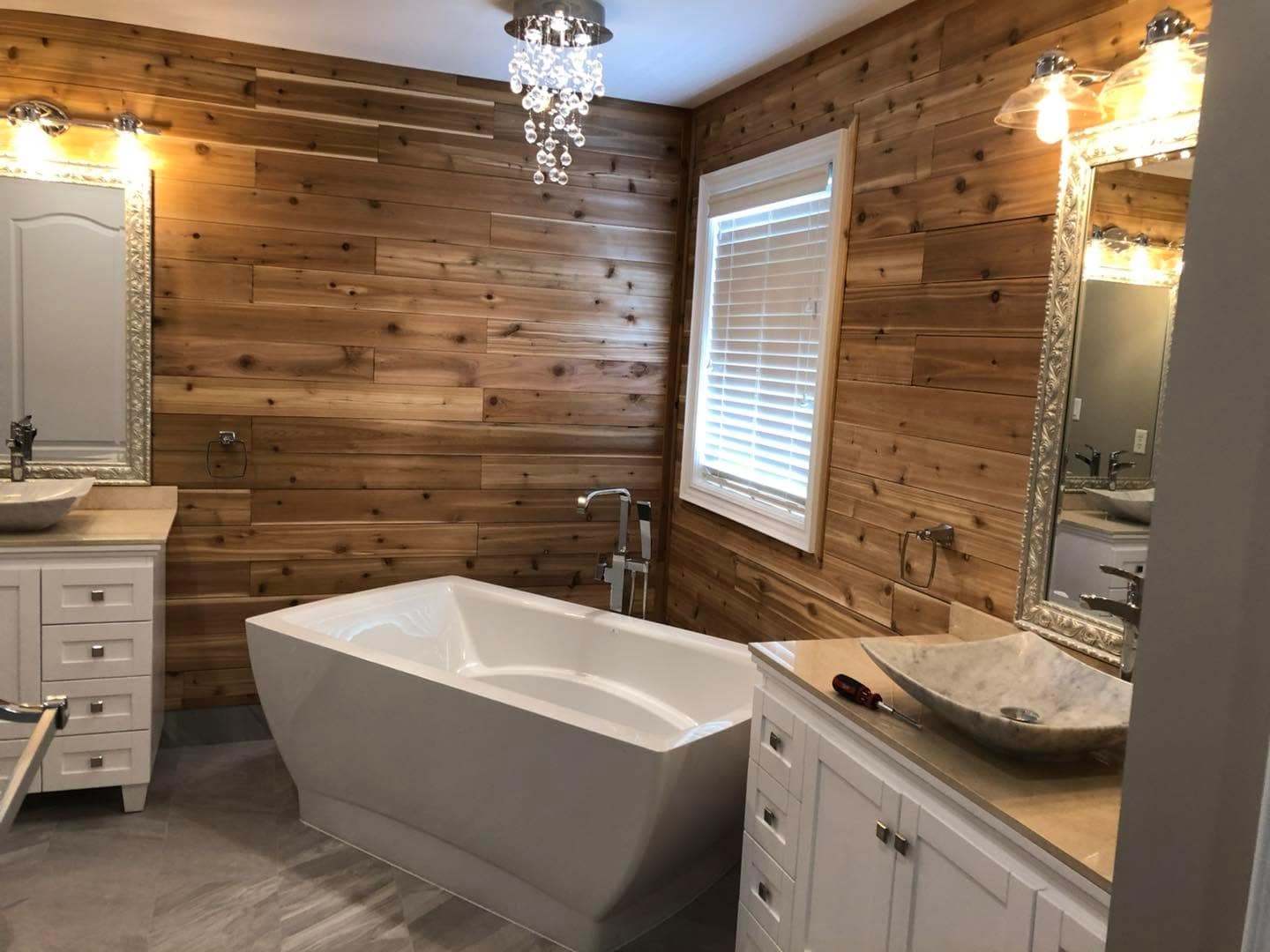 Warm cedar-lined bathroom with a freestanding tub, built by AEG Home Improvements