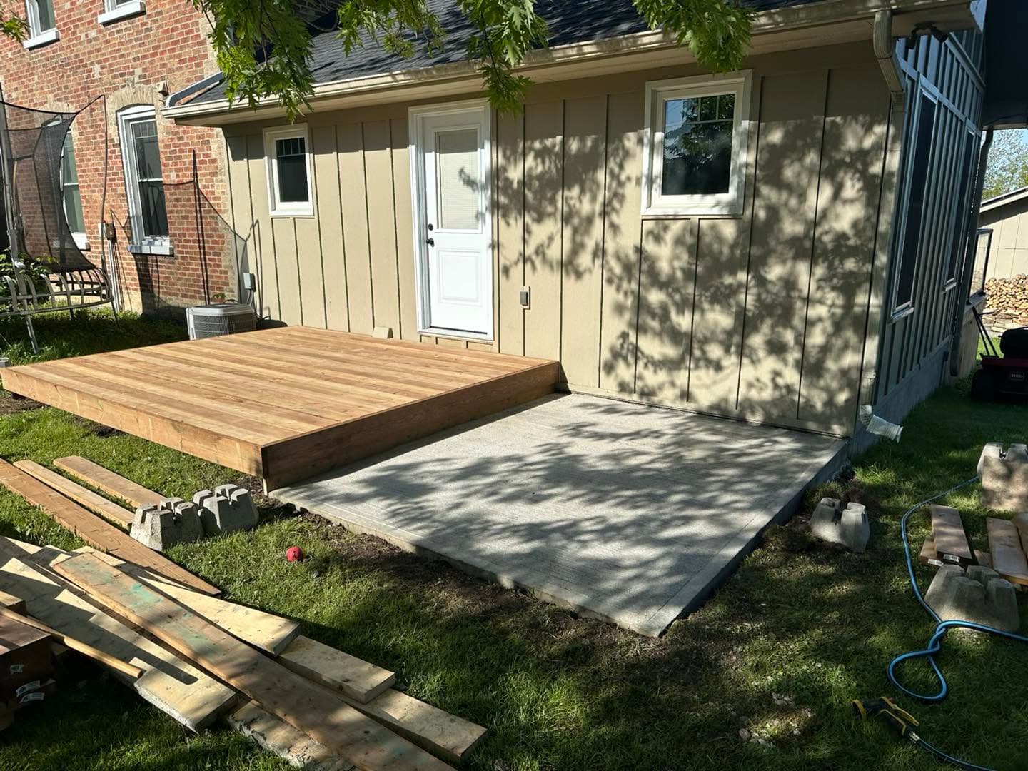 Low-profile ground level deck along the back of a home