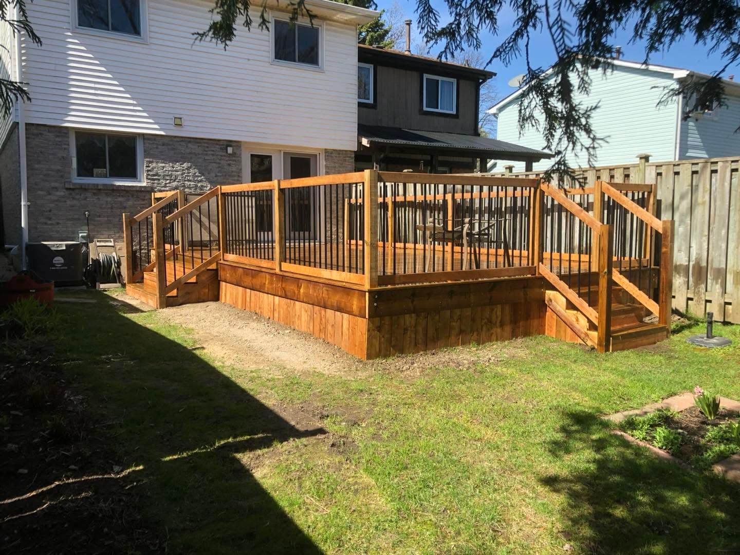 Large multi-level backyard deck with railings