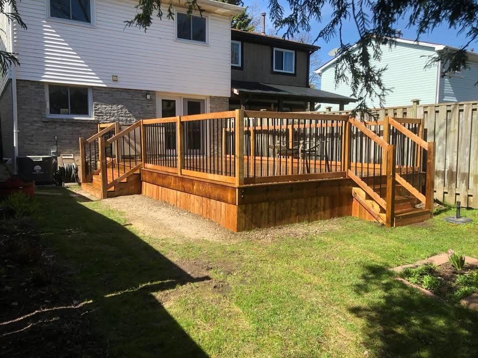 Raised backyard deck with cedar railings