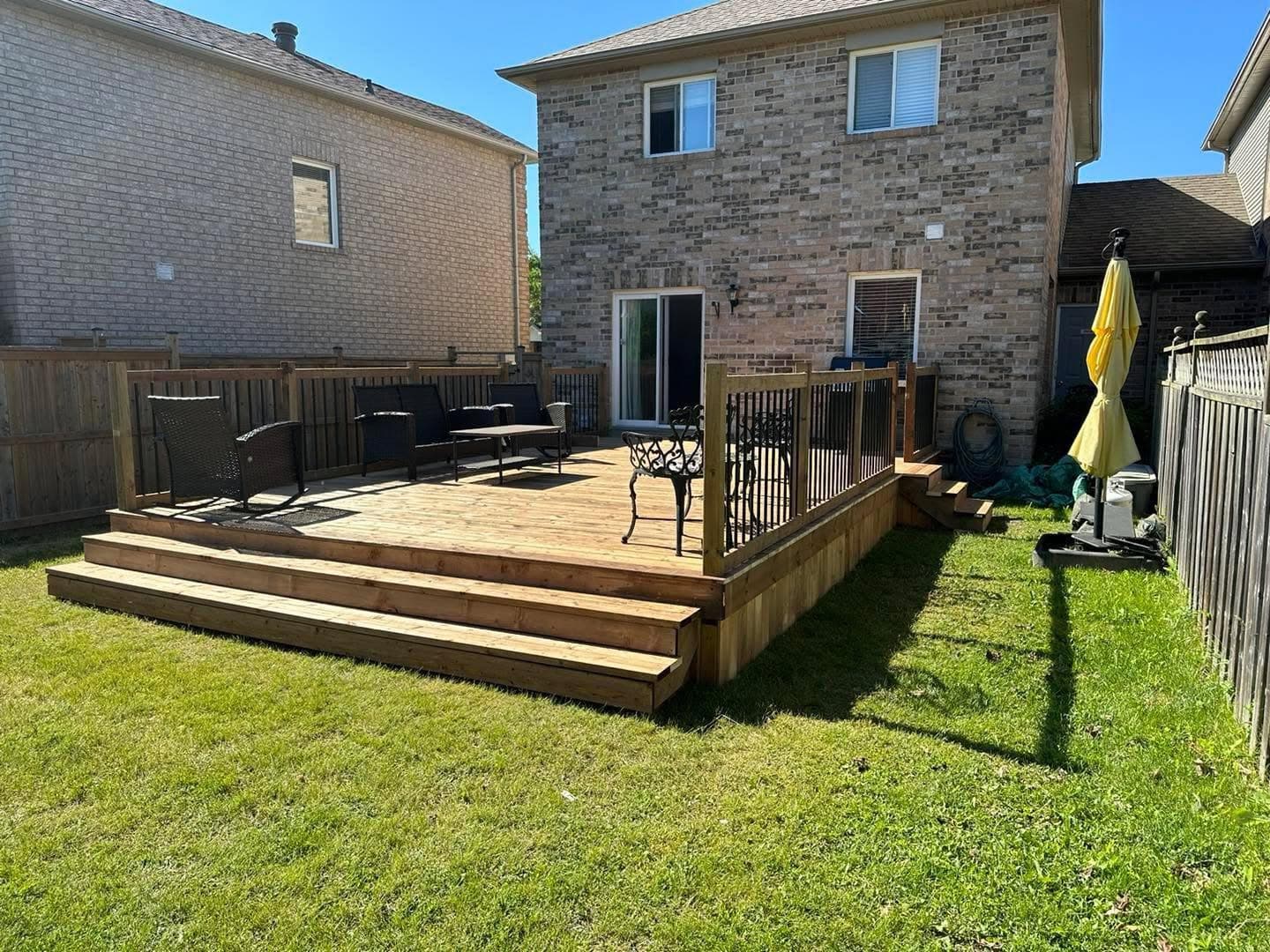 Finished backyard deck on a brick home built by AEG Home Improvements